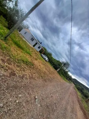 a house on a hill with a car parked on it at Casa en Boca del Río in Las Tapias