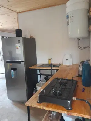 a kitchen with a stove and a refrigerator at Casa en Boca del Río in Las Tapias