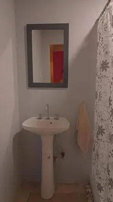 a bathroom with a white sink and a mirror at Casa en Boca del Río in Las Tapias