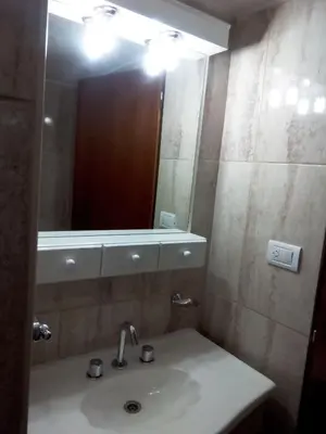 a bathroom with a sink and a mirror at Victor Hotel in Villa Carlos Paz