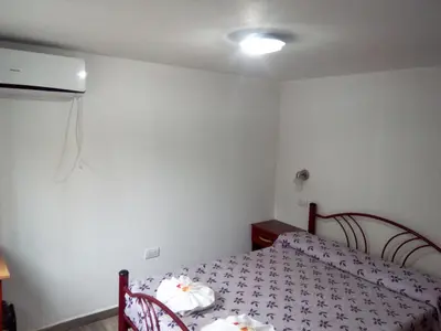 a small bedroom with a bed and a light at Victor Hotel in Villa Carlos Paz