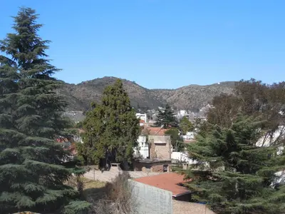 a view of a town with trees and mountains at Victor Hotel in Villa Carlos Paz
