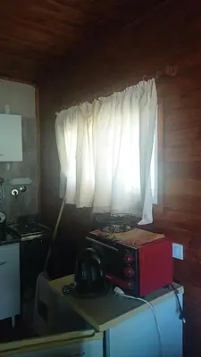 a microwave sitting on a table in a kitchen with a window at Kapo TEAM , el zorzal in Villa Amancay