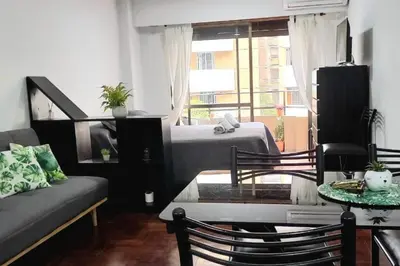 a living room with a bed and a couch and a table at Monoambiente en Nueva Cordoba in Cordoba