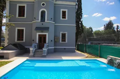a house with a swimming pool in front of it at Village Vistello in Cordoba