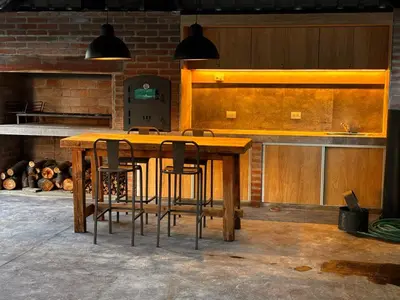 a kitchen with a wooden table and some chairs at Village Vistello in Cordoba