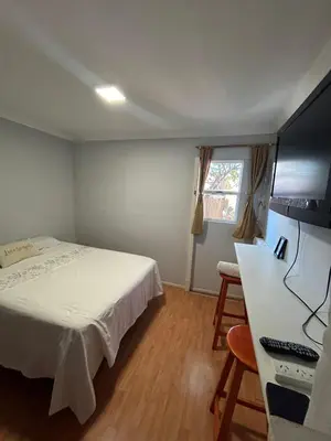a bedroom with a bed and a desk with a computer at La Casa de Petro in Cordoba