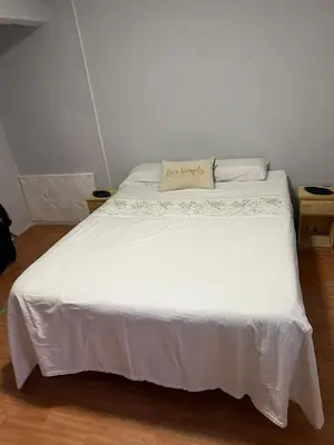 a white bed with a pillow on top of it at La Casa de Petro in Cordoba