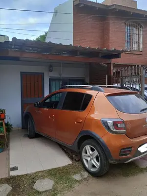 an orange car parked in front of a house at La Casa de Petro in Cordoba