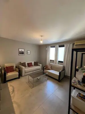 a living room with couches and a coffee table at Departamento equipado in Río Cuarto