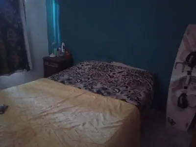 a small bedroom with a bed and a night stand at Colores de arguello in Cordoba