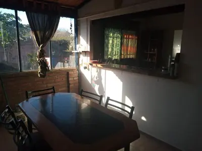 a dining room with a table and chairs and a window at Colores de arguello in Cordoba