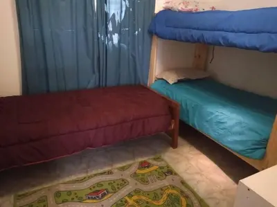 a bedroom with a bunk bed and a rug at Colores de arguello in Cordoba