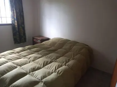 a large bed in a room with a window at Colores de arguello in Cordoba