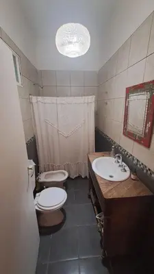 a bathroom with two sinks and a toilet and a sink at Casa amplia en las sierras de San Luis in San Francisco del Monte de Oro