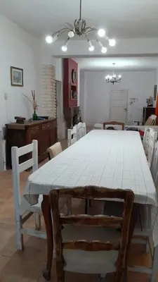 a dining room with a white table and chairs at Casa amplia en las sierras de San Luis in San Francisco del Monte de Oro