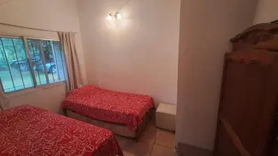 a small room with two beds and a window at Casa amplia en las sierras de San Luis in San Francisco del Monte de Oro