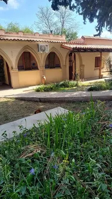 a house with a garden in front of it at Hospedaje FliaMaria in San Javier