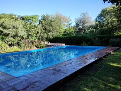 a swimming pool in the yard of a house at Hospedaje FliaMaria in San Javier