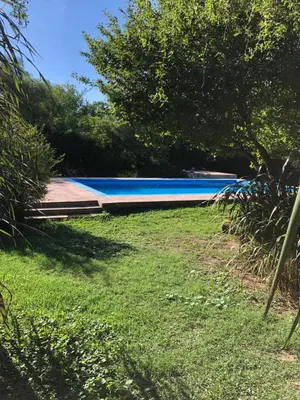 a swimming pool in the yard of a house at Hospedaje FliaMaria in San Javier