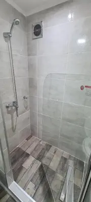 a shower with a glass door in a bathroom at Atardecer Soñado in Villa Cura Brochero