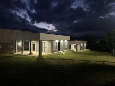 a small house in a field at night at Cabañas Adorable Tranquilidad in Cavalango