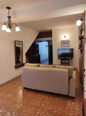 a living room with a couch and a flat screen tv at Being in Cordoba