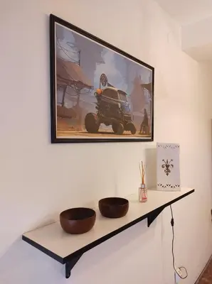 a picture hanging on a wall with two bowls on a shelf at Being in Cordoba