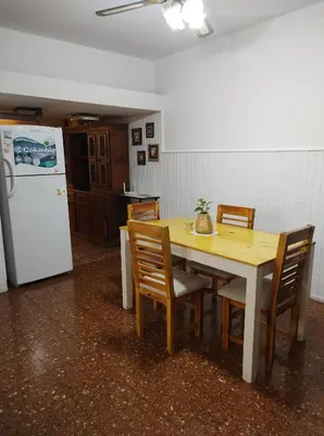 a kitchen with a table and chairs and a refrigerator at Being in Cordoba