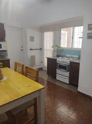 a kitchen with a stove and a table with chairs at Being in Cordoba