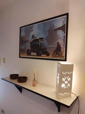 a shelf with a picture and a toy car on it at Being in Cordoba