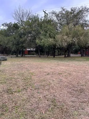 a field of grass with trees in the background at cabañas Villa de las rosas in Villa de Las Rosas