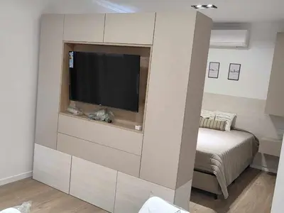 a living room with a flat screen tv on a wall at Villa Carlos Paz departamento con pileta in Villa Carlos Paz