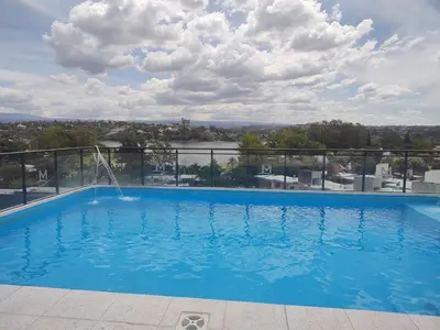 a swimming pool on the roof of a building at Dpto frente al Lago Carlos Paz in Villa Carlos Paz