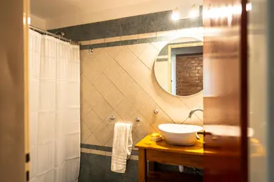 a bathroom with a sink and a mirror at Cabañas Ocho Soles in Las Rabonas