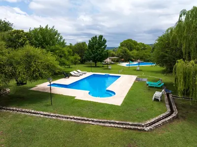 an image of a swimming pool in a yard at Cabañas Ocho Soles in Las Rabonas