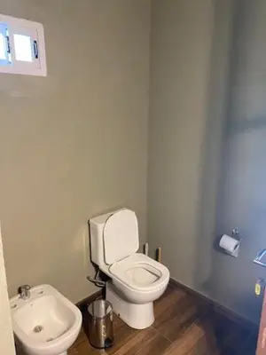 a bathroom with a white toilet and a sink at lo de lucio in Almafuerte