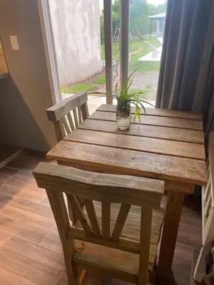 a wooden table with a potted plant on top of it at lo de lucio in Almafuerte