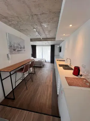 a kitchen and living room with a table and chairs at Departamentos en Gral Paz a pasos de clínicas in Cordoba