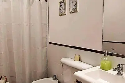 a bathroom with a sink and a toilet and a mirror at Excelente departamente nuevo! in Cordoba
