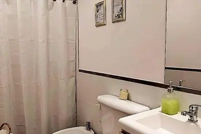 a bathroom with a sink and a toilet and a mirror at Excelente departamente nuevo! in Cordoba