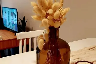 a vase with flowers in it on a table at Excelente departamente nuevo! in Cordoba