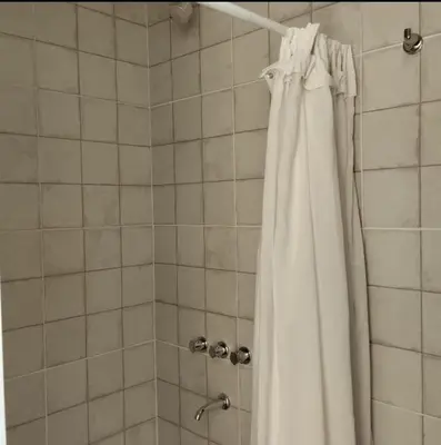 a shower with a white shower curtain in a bathroom at Casa Olivia Habitación privada in Alta Gracia