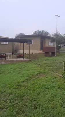 a house with a picnic table in a yard at Colinas Del Mirador in Villa Carlos Paz