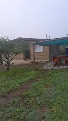 a yard with a picnic table and a house at Colinas Del Mirador in Villa Carlos Paz