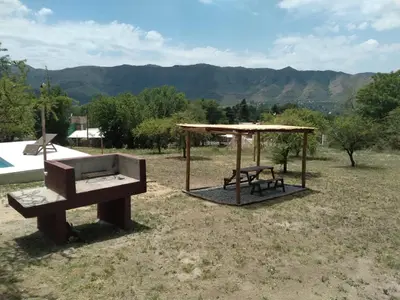 a park with a bench and a table and a pavilion at Colinas Del Mirador in Villa Carlos Paz