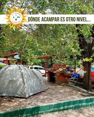 a tent in a yard with a sign that reads ddo agenda is otro at La Ribera Hotel Dormis Camping in Villa Carlos Paz