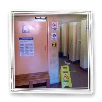 a door in a hallway with a sign on it at La Ribera Hotel Dormis Camping in Villa Carlos Paz