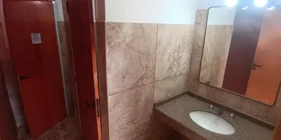 a bathroom with a sink and a mirror at La Ribera Hotel Dormis Camping in Villa Carlos Paz