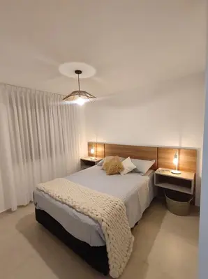 a bedroom with a large bed and two night stands at Hermoso Departamento confort y calidad in Cordoba